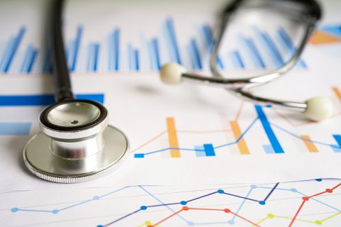 Stethoscope on charts and graphs spreadsheet paper, Finance, Account, Statistics, Investment, Analytic research data economy and Business company concept.